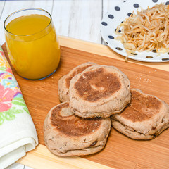 Breakfast of  hash brown potato, muffin and juice.