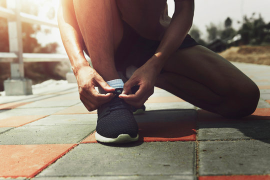 man runer typing running shoe