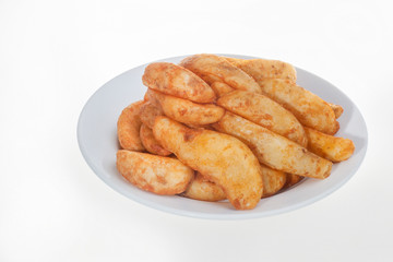Close up of fried potatoes with plate