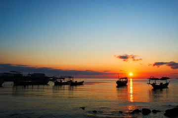 Fototapeta na wymiar Beautiful sunrise on tropical beach Koh rong cambodia Landscape with longtail boats while sun is going up