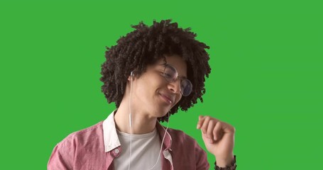 Happy man listening music on earphones and dancing in slow motion