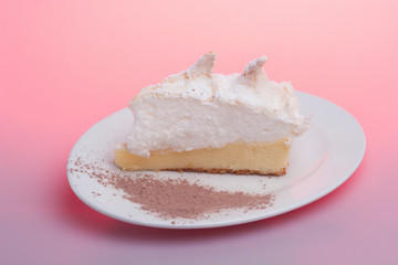 Piece of tasty white cake with plate