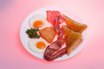 Breads and meats with eggs on plate
