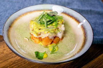Pickled cod. European cuisine. The work of a professional chef. Dish from a restaurant or cafe menu. Close-up