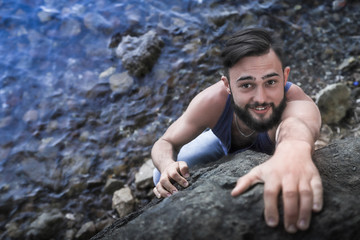 Handsome young man near sea on rocks in Turkey