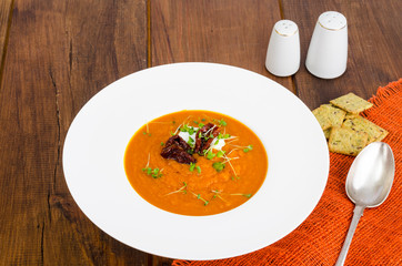 Delicious vegetable cream soup with tomatoes and microgreens.