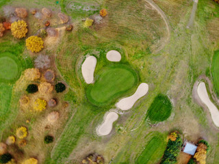 Aerial view of a golf course. Beautiful colorful trees and green course during autumn/winter season...