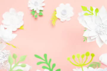 White paper flowers on pink background. Floral