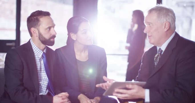 4K Smartly dressed young couple in a meeting with their bank manager
