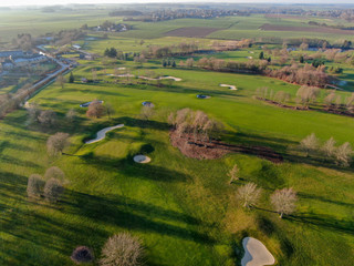 Aerial view of a golf course. Beautiful colorful trees and green course during autumn/winter season...