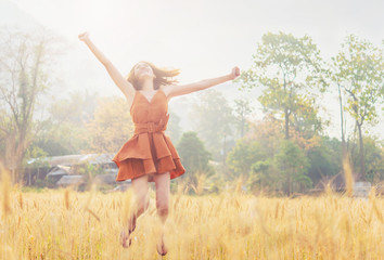 Happy time Asian woman in barley field.Summer concept. 