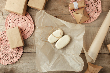 Holiday natural decoration or gift idea - natural soap in paper package, zero waste lifestyle concept, monochrome background, copy space