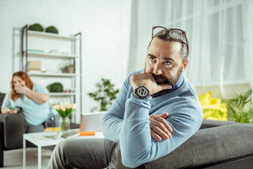 Emotional bearded man being deep in thoughts