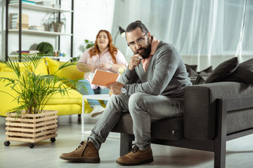 Obraz premium Serious bearded male person creating plan of action