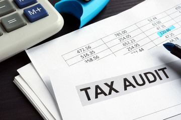 Tax audit. Financial report on a desk.