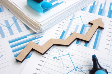 Business growth concept. Financial report with graphs and arrow. - obrazy, fototapety, plakaty