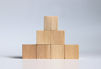 Wooden blocks stacked in the shape of a pyramid.