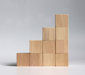 A stack of wooden blocks stacked in the shape of a staircase.