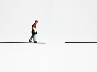 Obraz premium A miniature man walking with a bag.