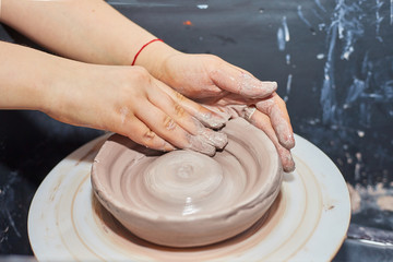 Modeling of clay on a potter's wheel In the pottery workshop