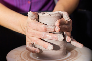 Modeling of clay on a potter's wheel In the pottery workshop