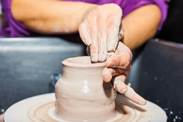 Modeling of clay on a potter's wheel In the pottery workshop