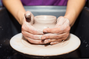 Modeling of clay on a potter's wheel In the pottery workshop