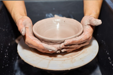 Modeling of clay on a potter's wheel In the pottery workshop