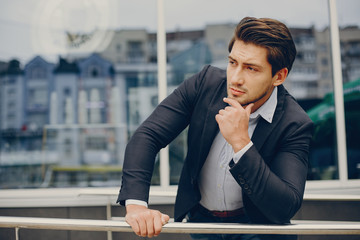 Man in a stylish suit. Businessman in a summer city