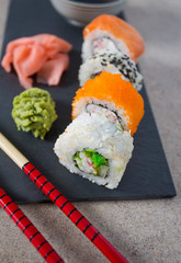 sushi rolls on black stone plate