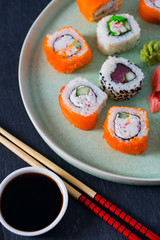 sushi rolls on black stone plate