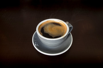 Americano coffee on vintage wooden table in cafe