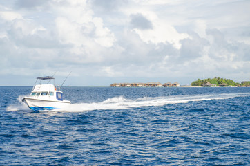 Fototapeta premium landscape the Indian Ocean with houses on water and the boat