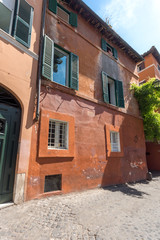 Fototapeta na wymiar Building and street in Trastavete district in city of Rome, Italy