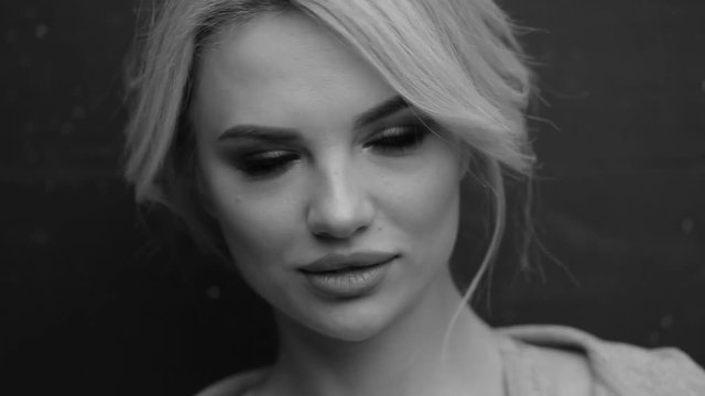 Closeup portrait of a beautiful girl. Black and white video.
