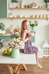 Obraz premium girl with a cup in the bright kitchen in the style of Provence