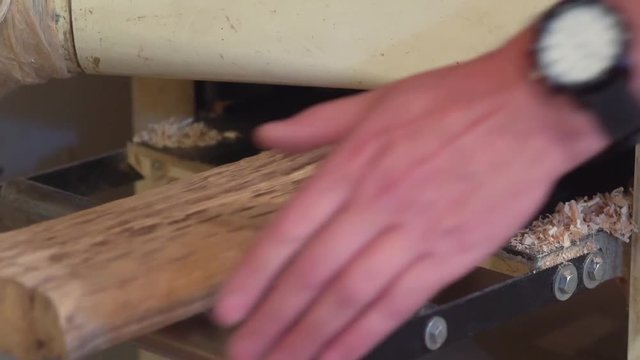 Joiner whittle workpiece of wood with jack-plane slow motion. Joiner whittle workpiece of wood with jack-plane
