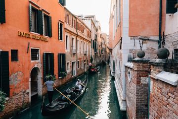 Fototapeta na wymiar Panoramic view of Venice narrow canal with historical buildings and gondolas