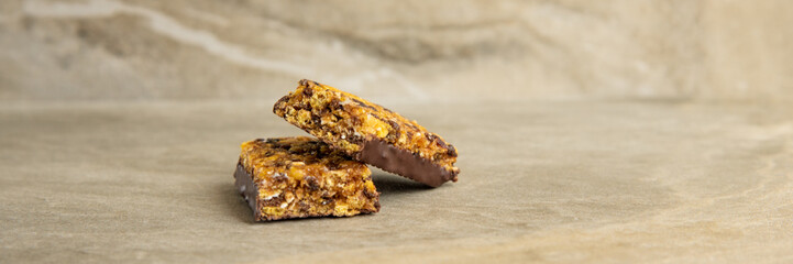 Muesli and cereal bar on marble stone background