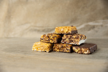 Various muesli bars on marble stone background