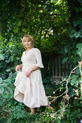 Portrait of beautiful blonde woman in summer garden