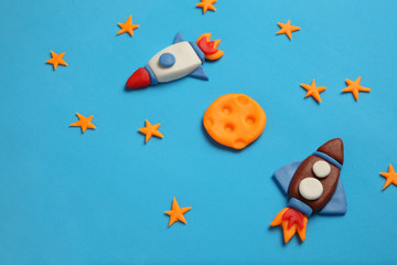 Two kid (child) rocket in space, adventure and science. Stars, and moon. Plasticine art, cartoon.