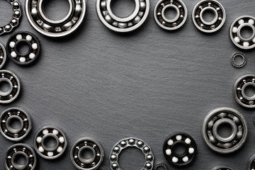 Frame of various ball bearings with free space. Technology and machinery industrial background.