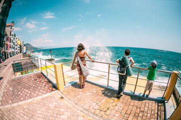 Woman with children look at the sea.