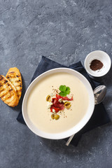 Bowl cheese soup bacon olives top view copy space