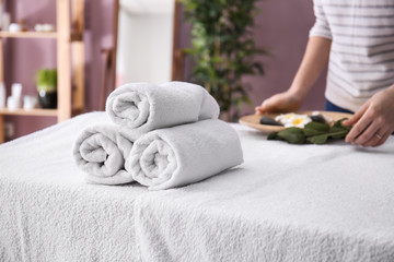 Rolled towels on table in spa salon