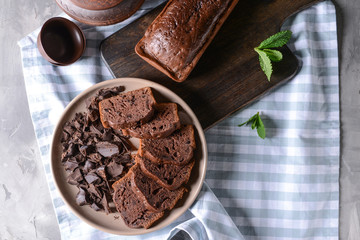 Plate with pieces of tasty chocolate cake on table