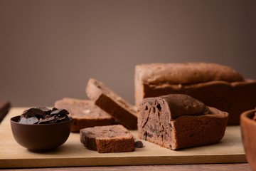 Tasty sliced chocolate cake on table