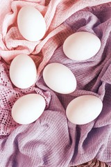 Chicken eggs on pastel background. Easter decoration. Flat lay, top view, copy space.