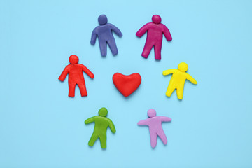 Multicolored plasticine figures of people and heart. Racism and equality of people in world.